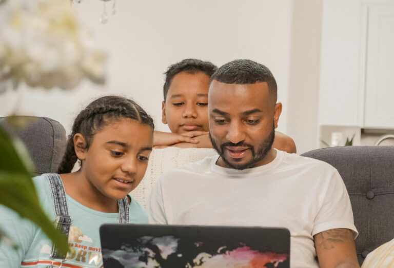 AMERICAN FAMILY WORKING ON LAPTOP AT HOME